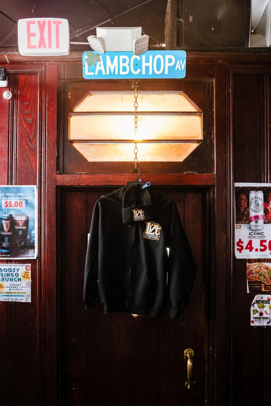 The tavern's wood door under the Lambchop Av street sign